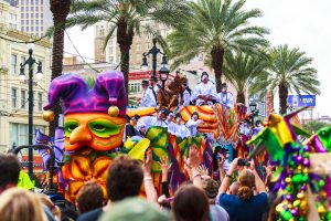 ardi Gras parades through the streets of New Orleans. People are celebrating and welcoming locals and visitors. This is the biggest annual  celebration  of the city.