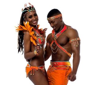 Young couple performing samba dance over white