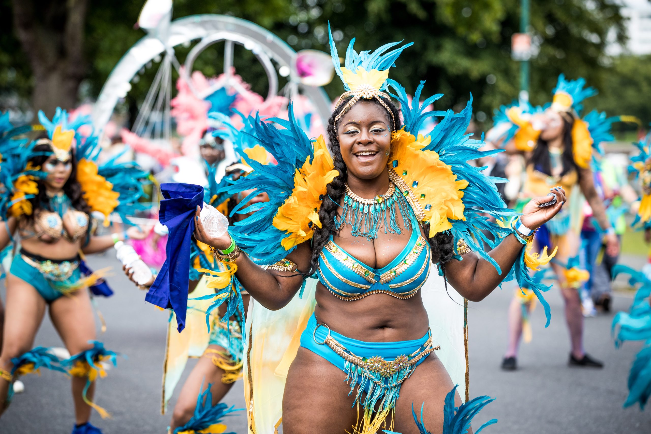 Woman in colorful costume dancing and singing on the streets during a Carnival parade