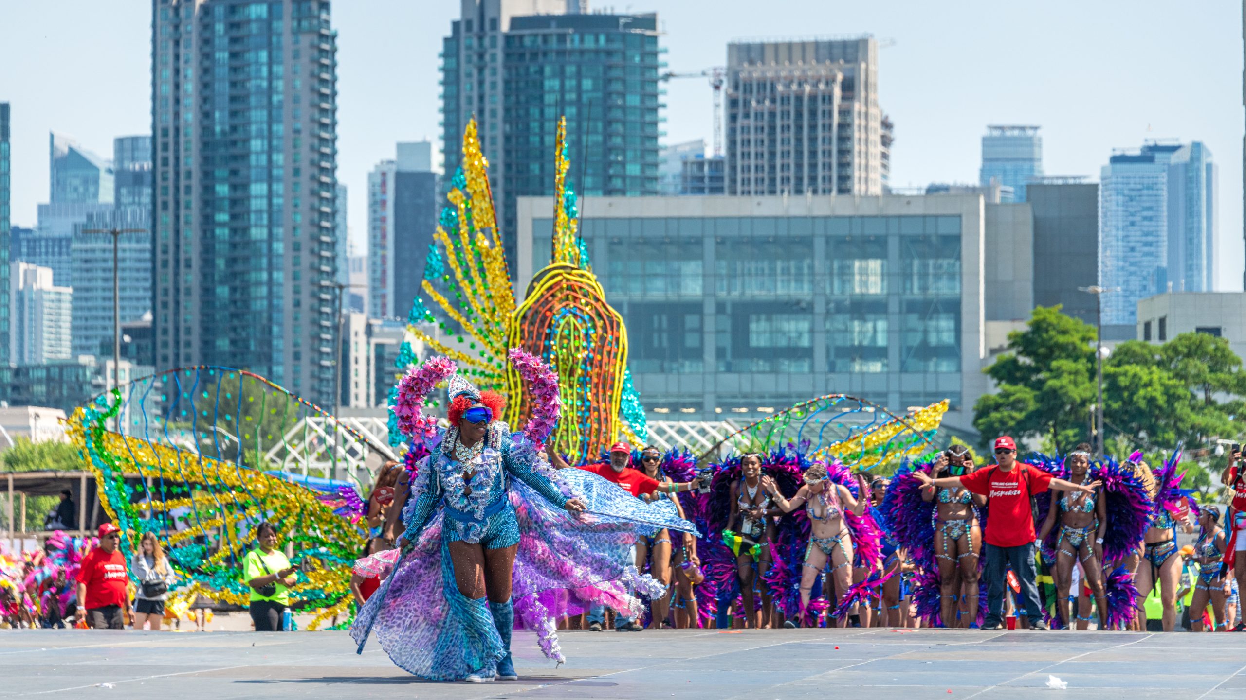 Leader of a dancers group showing a large multi-color costume. The Toronto Caribbean Carnival or Caribana is one of the largest street festivals in North America and it attracts thousands of tourists every year leaving about half a million dollars to the economy of Toronto city.