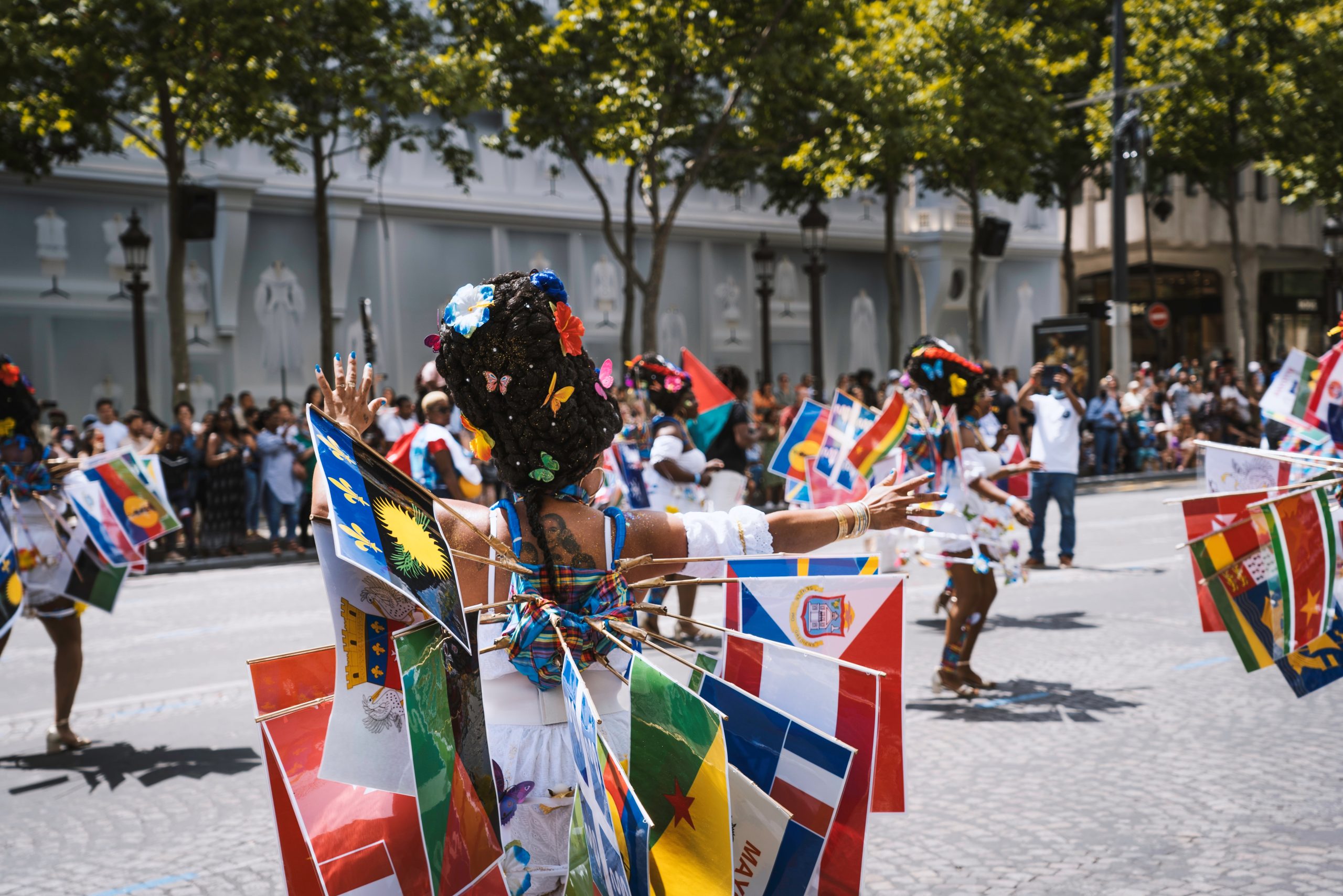 Women wearing Caribbean flags as part of their Carnival costumes during a parade