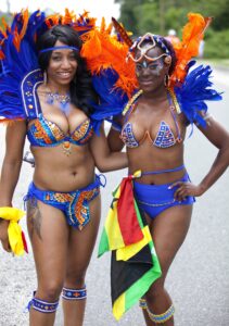 Participants in brightly colored feathered costumes parading at the Caribbean Carnival in Atlantic City, New Jersey, July 2016