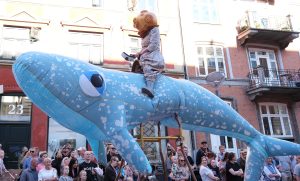 Blue whale float featured in a Carnival parade, showcasing creative float design