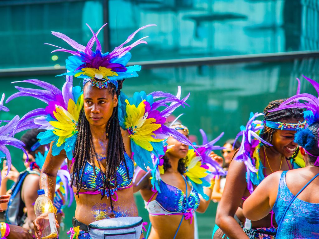 Montreal, Canada - July 7 2019: Happy montrealais dressing colorful dancing in Caribbean parade in downtown Montreal
