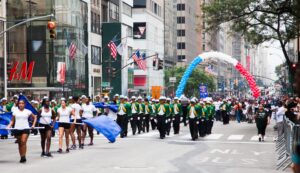 Overview of a colorful crowd with various Carnival troupes at the New York Labor Day Parade