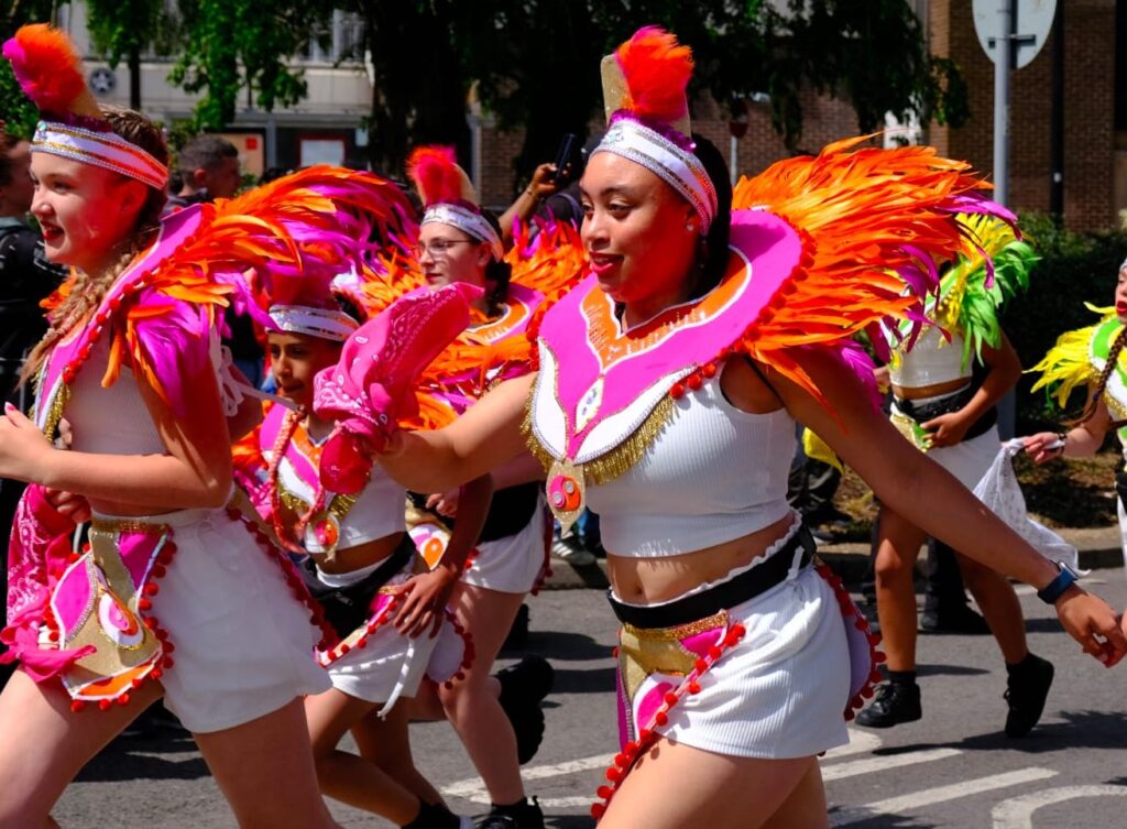 Carnival troupe in colorful costumes at the 2025 Luton International Carnival, celebrating Caribbean culture, music, and dance at one of the UK’s largest multicultural festivals.