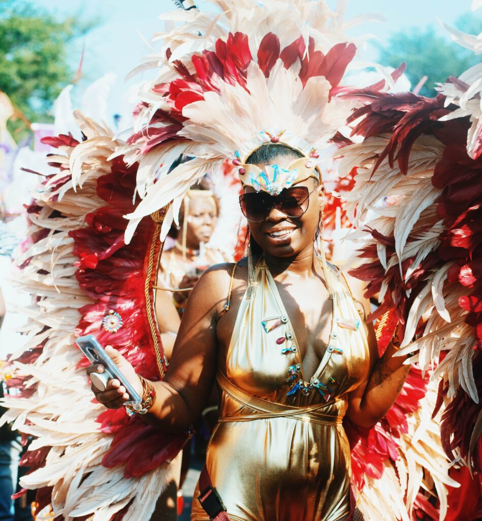 Woman in vibrant carnival costume representing Miami Carnival, showcasing Caribbean culture, colorful masquerade, music, and dance at one of the biggest carnivals in the United States.