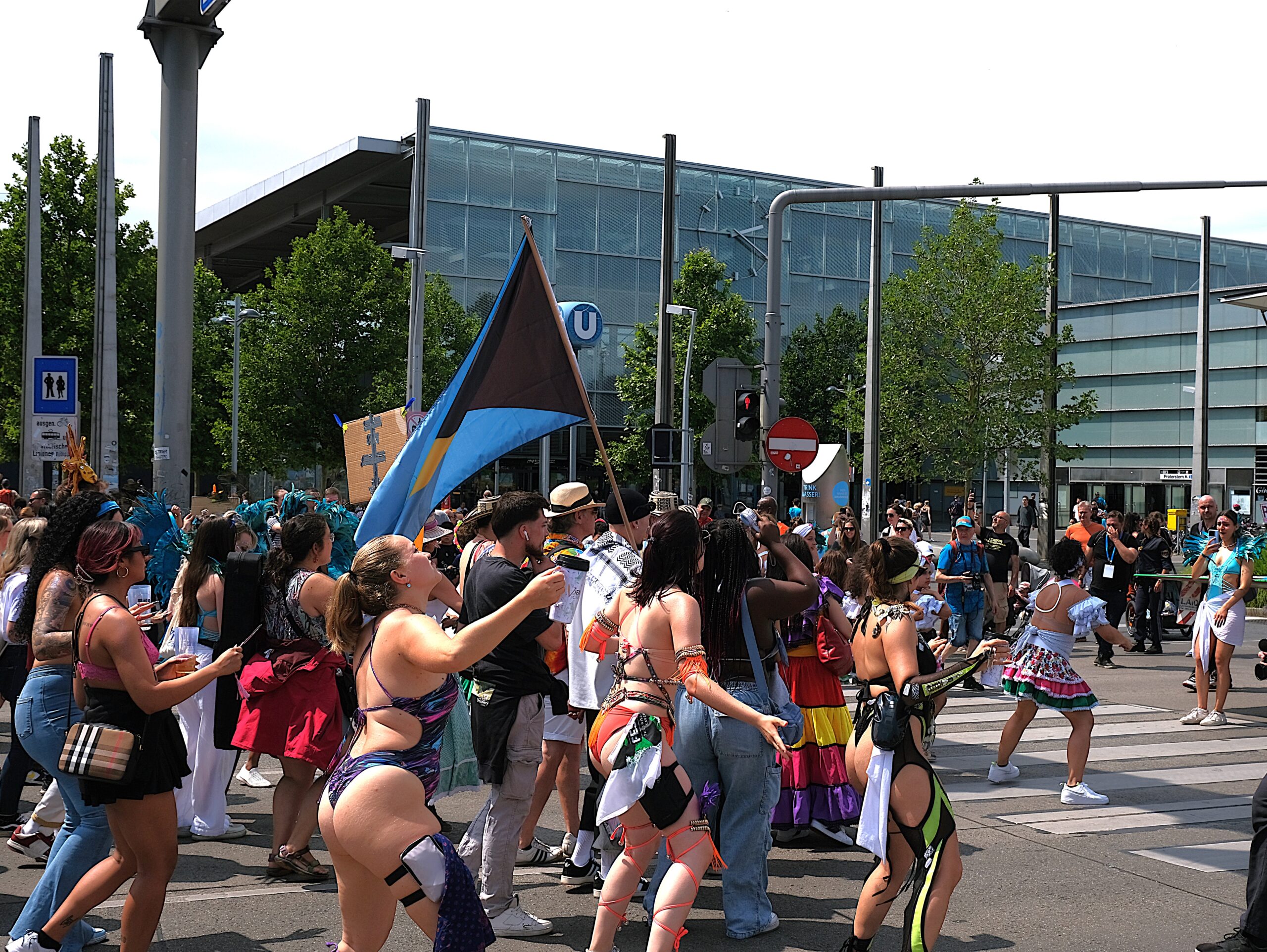 Crowd enjoying the Vienna Carnival Road March 2024, celebrating Caribbean culture with music, dance, costumes, and vibrant street parade energy in Austria.