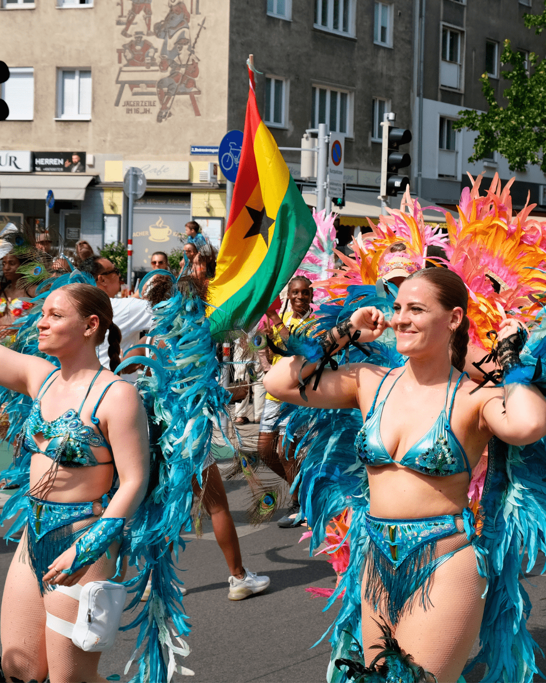 Women in vibrant costumes dancing at the Vienna Carnival Road March 2025, filling the streets with music, movement, and festive energy.