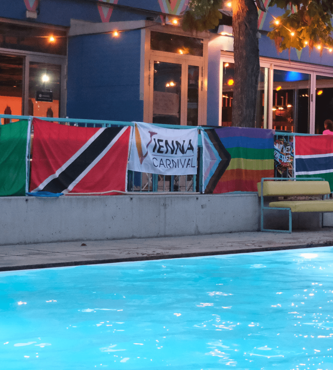 Pool decorated with Caribbean flags at the Vienna Carnival Island Breeze Pool Party 2025, celebrating Caribbean culture with music, dance, and festive vibes in Austria.