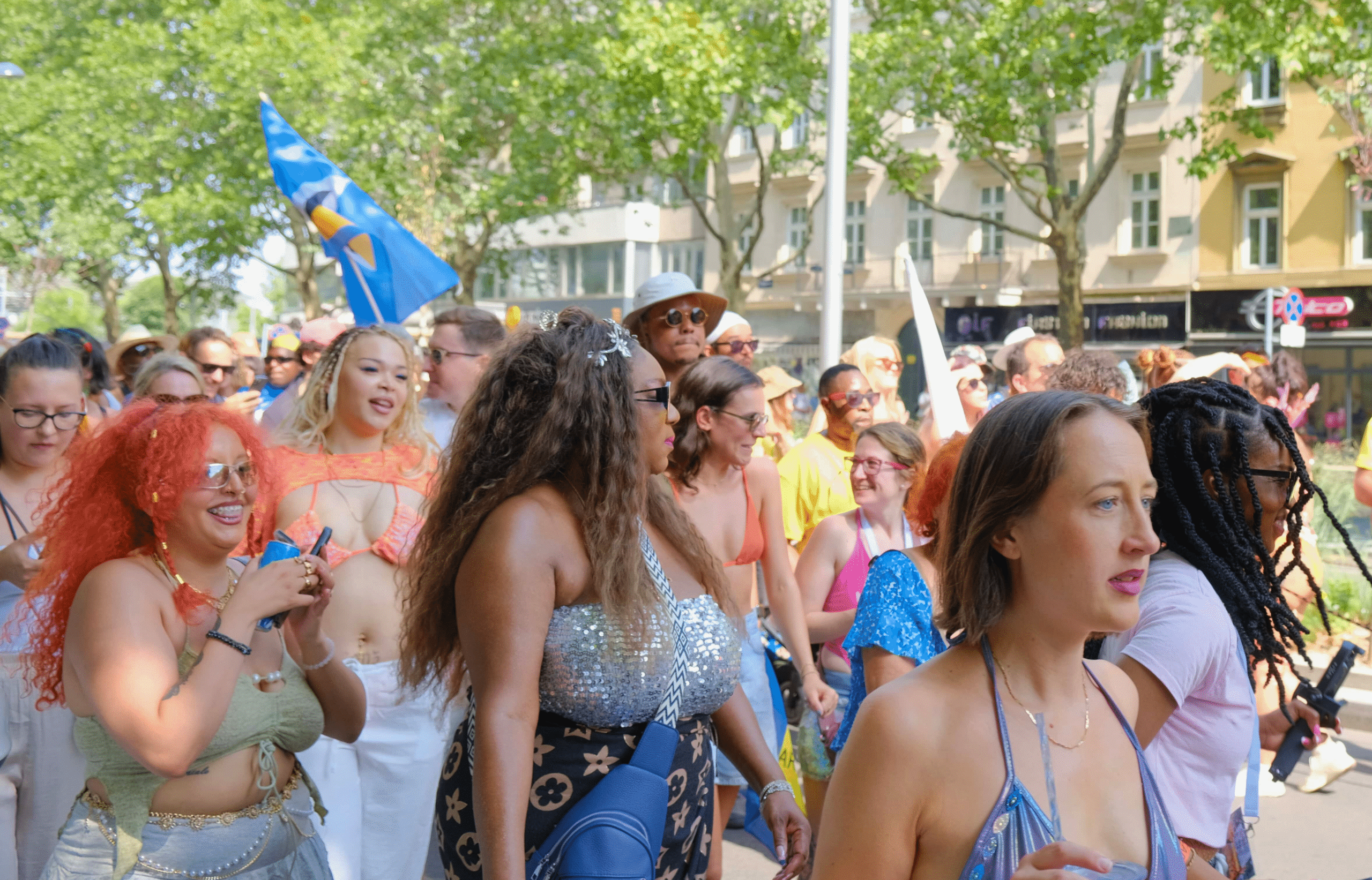 Happy crowd of people dancing, laughing, and marching together at the Vienna Carnival Road March on July 6, 2025, celebrating Caribbean culture in Austria.