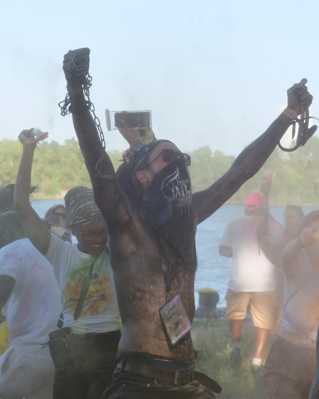 Carnival reveler covered in paint and powder celebrating J’Ouvert-style festivities, highlighting traditional Caribbean carnival terms and rituals.
