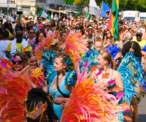 Participants in vibrant feathered costumes celebrating at Vienna Carnival street parade.