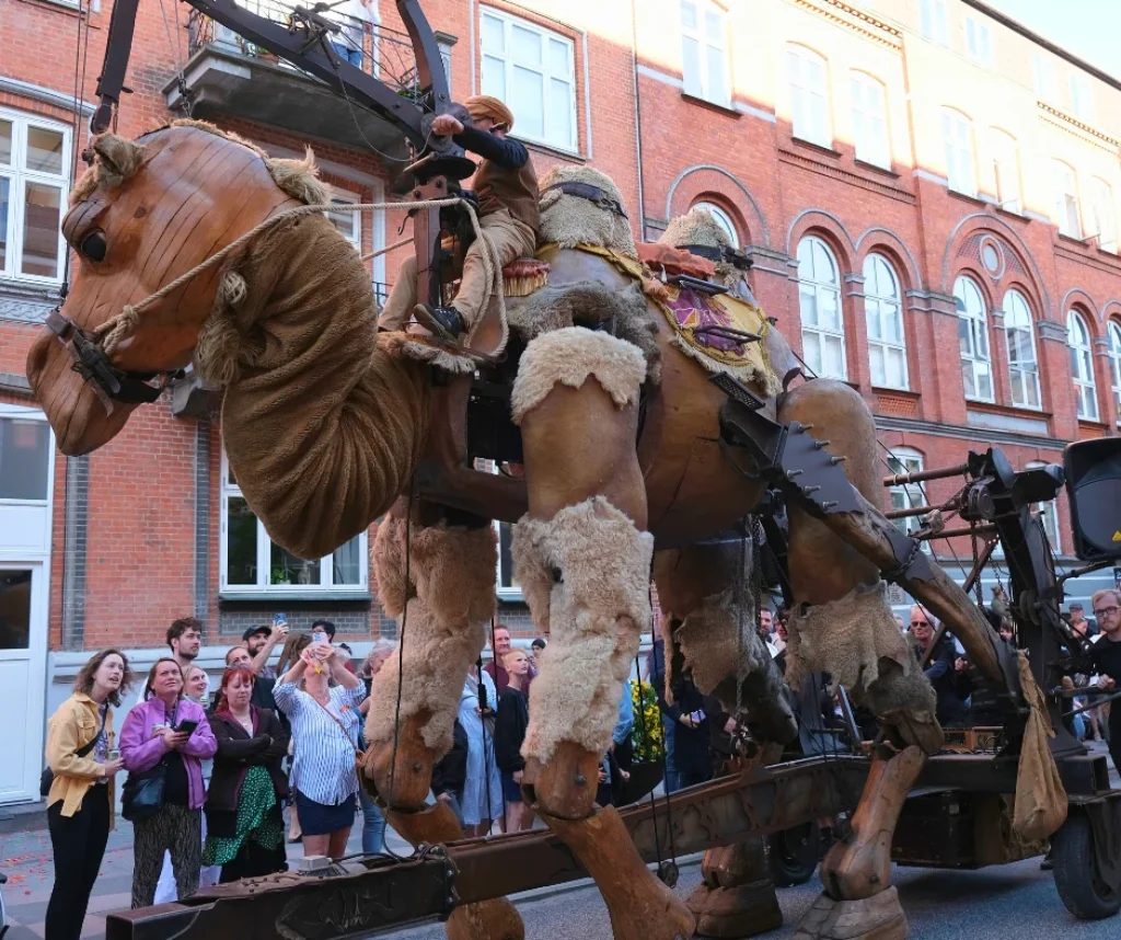 Large mechanical camel float moving through the streets during Aalborg Karneval parade.