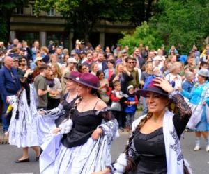 People in festive costumes dancing in a street parade in Berlin, showcasing Carnival celebrations as one of the top things to do in Berlin during Carnival weekend.