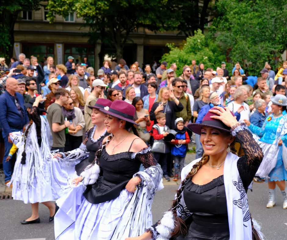 People in festive costumes dancing in a street parade in Berlin, showcasing Carnival celebrations as one of the top things to do in Berlin during Carnival weekend.