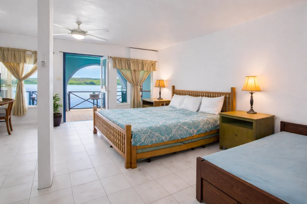 Spacious beachfront hotel room in Anguilla with balcony ocean view, ideal for visitors attending Anguilla Summer Festival 2026.