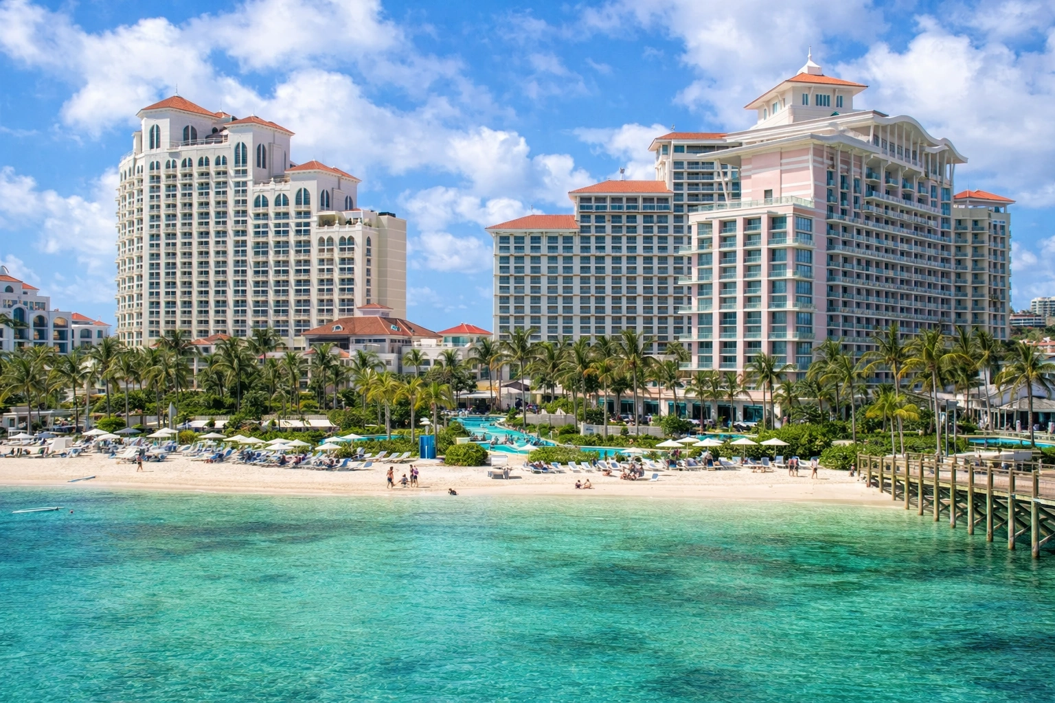 SLS Baha Mar hotel in Nassau with modern high-rise towers, palm-lined beach, and clear turquoise ocean – best hotels & areas to stay in nassau.
