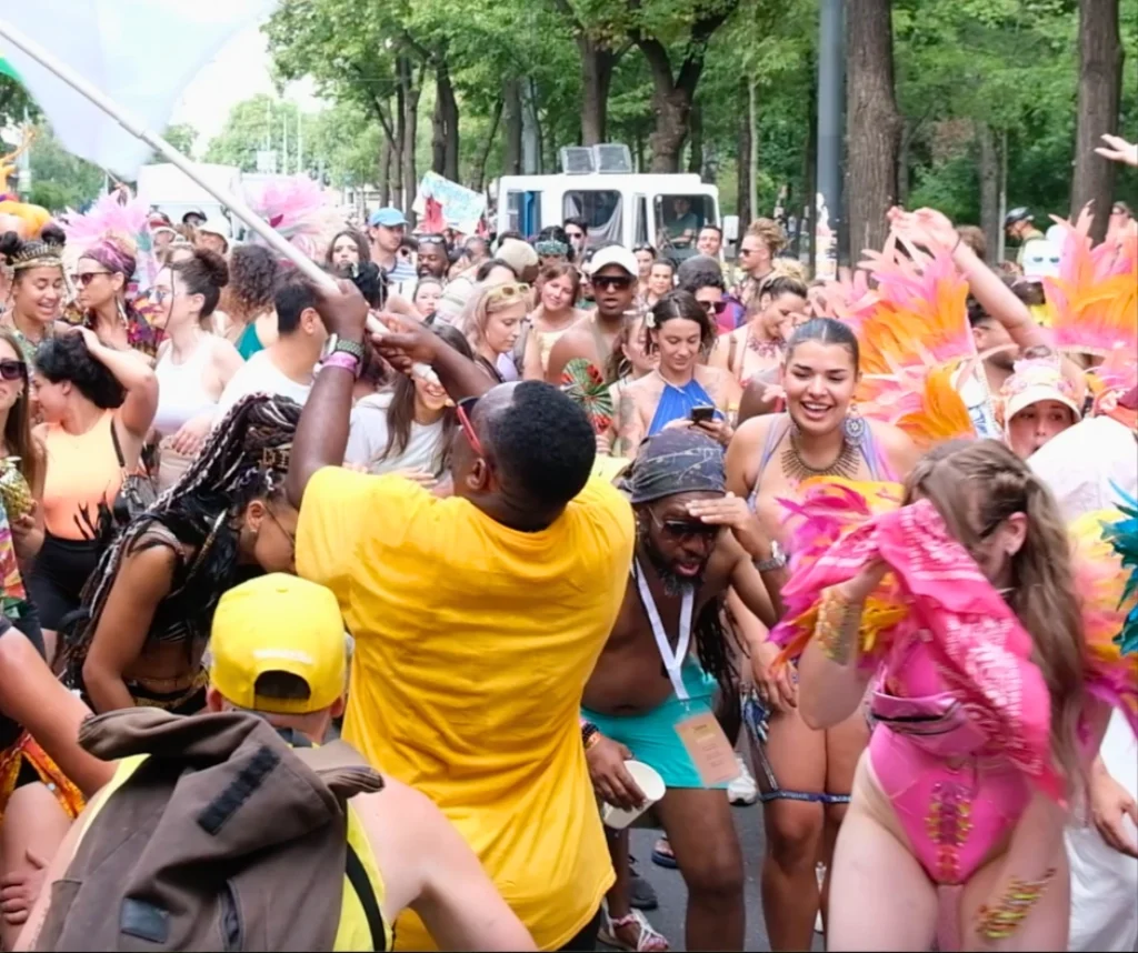 Crowds dancing in colorful costumes during the street celebrations of Vienna Carnival in Vienna, Austria.