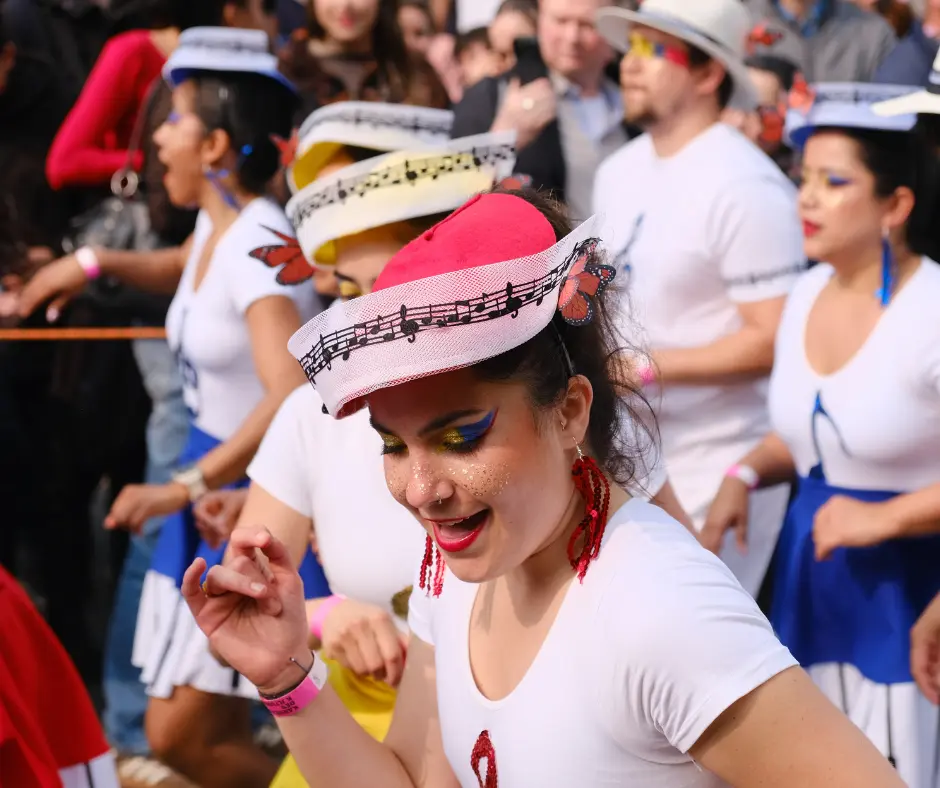 Dancers in white costumes and musical hats performing at Berlin Carnival parade