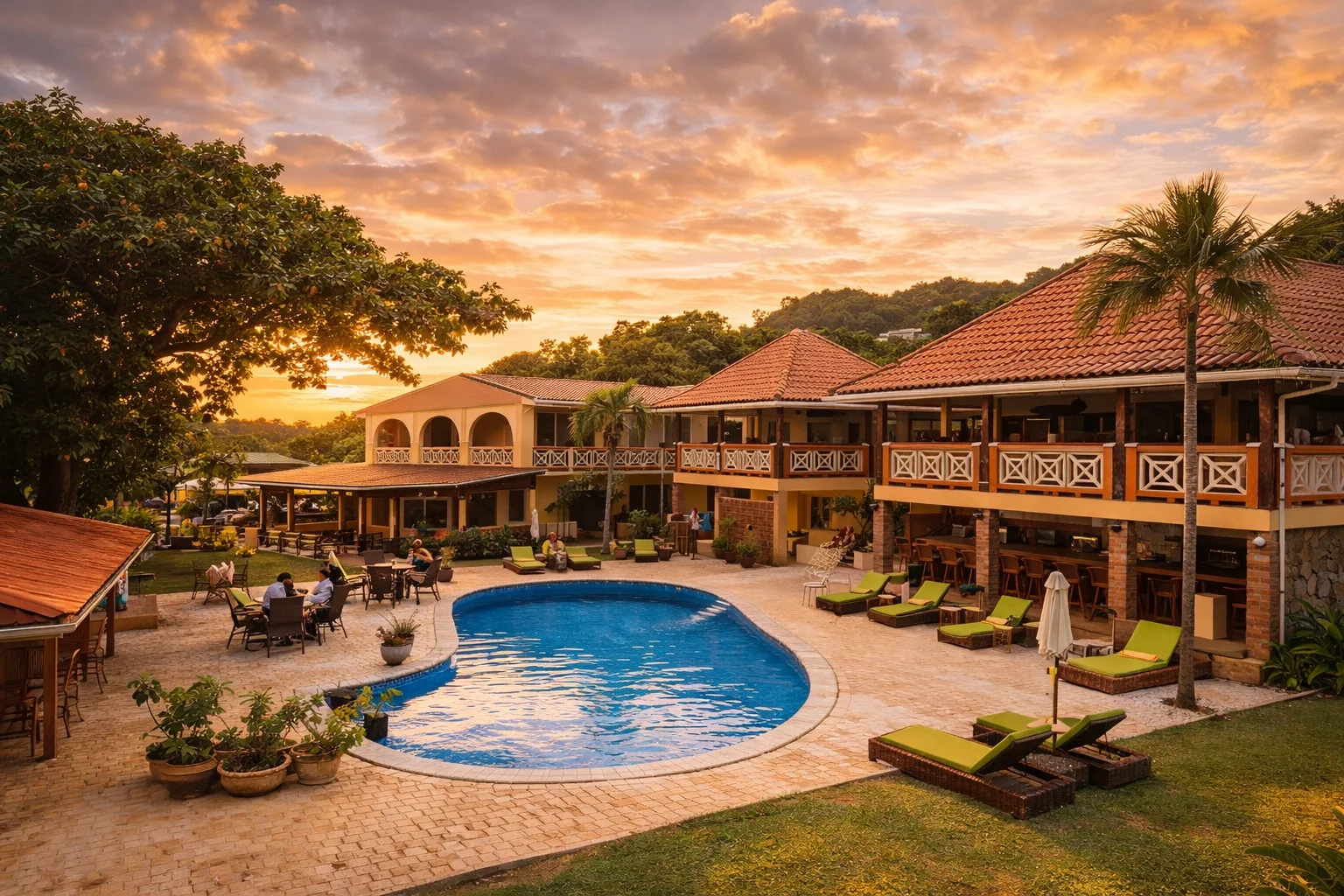 Sunset Shores Hotel pool courtyard with lounge chairs, tropical landscaping, and resort atmosphere at VincyMas Hotels.