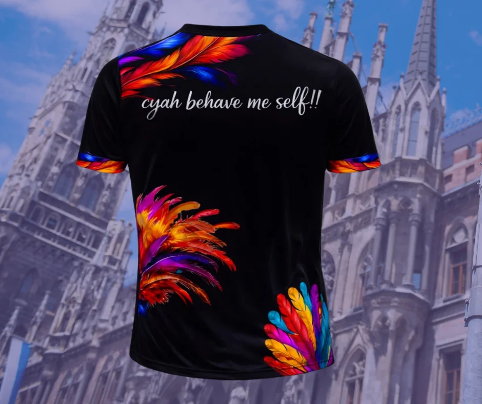 Back of Munich Carnival 2026 feather costume t-shirt featuring colorful feather accents and “cyah behave me self” slogan, Caribbean carnival vibe apparel
