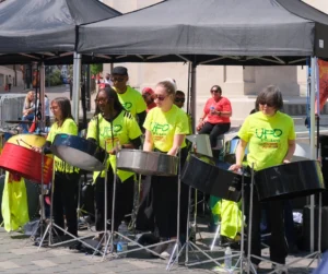 Steelpan band performing live at Luton Carnival in the UK with multiple players on steel drums