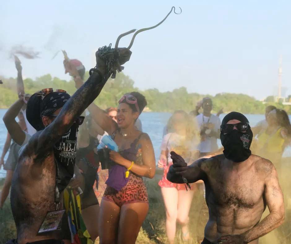 Revelers covered in paint and powder dancing at Misbehave J’ouvert during Vienna Carnival weekend