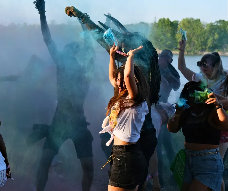 Partygoers dancing in clouds of blue powder at Misbehave J’ouvert during Vienna Carnival weekend
