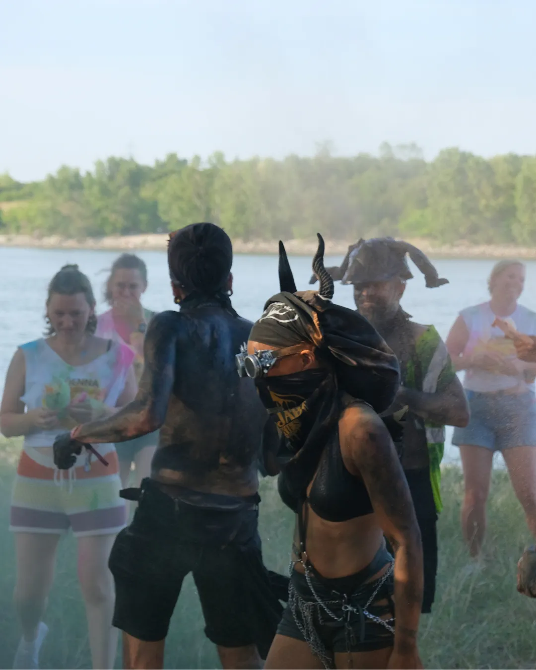 Masqueraders covered in paint and mud celebrating at Misbehave J’ouvert during Vienna Carnival