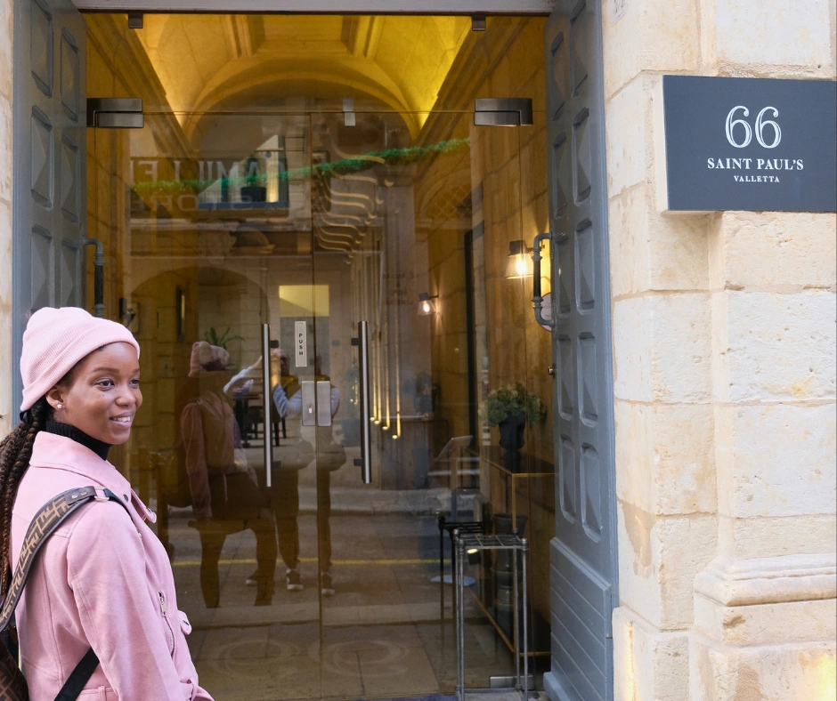 Traveler arriving at 66 Saint Paul's hotel in Valletta Malta during Malta Carnival
