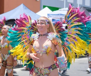 Woman wearing multicolor feather costume during SXM Carnival 2026 Grand Parade in St Maarten