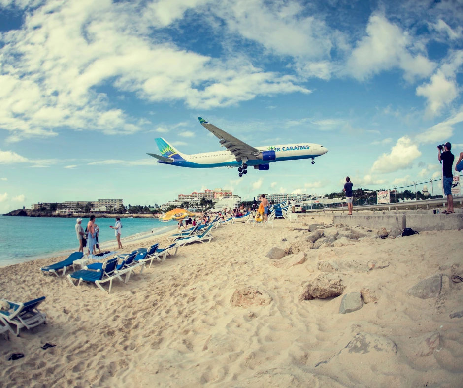 Airplane landing near Maho Beach in St Maarten during SXM Carnival travel season