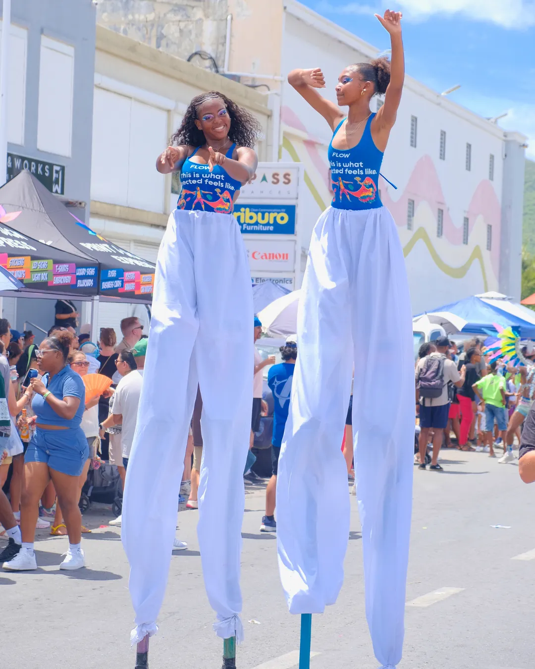 Stilt walkers performing at Caribbean carnival parade, featured as a carnival travel resource