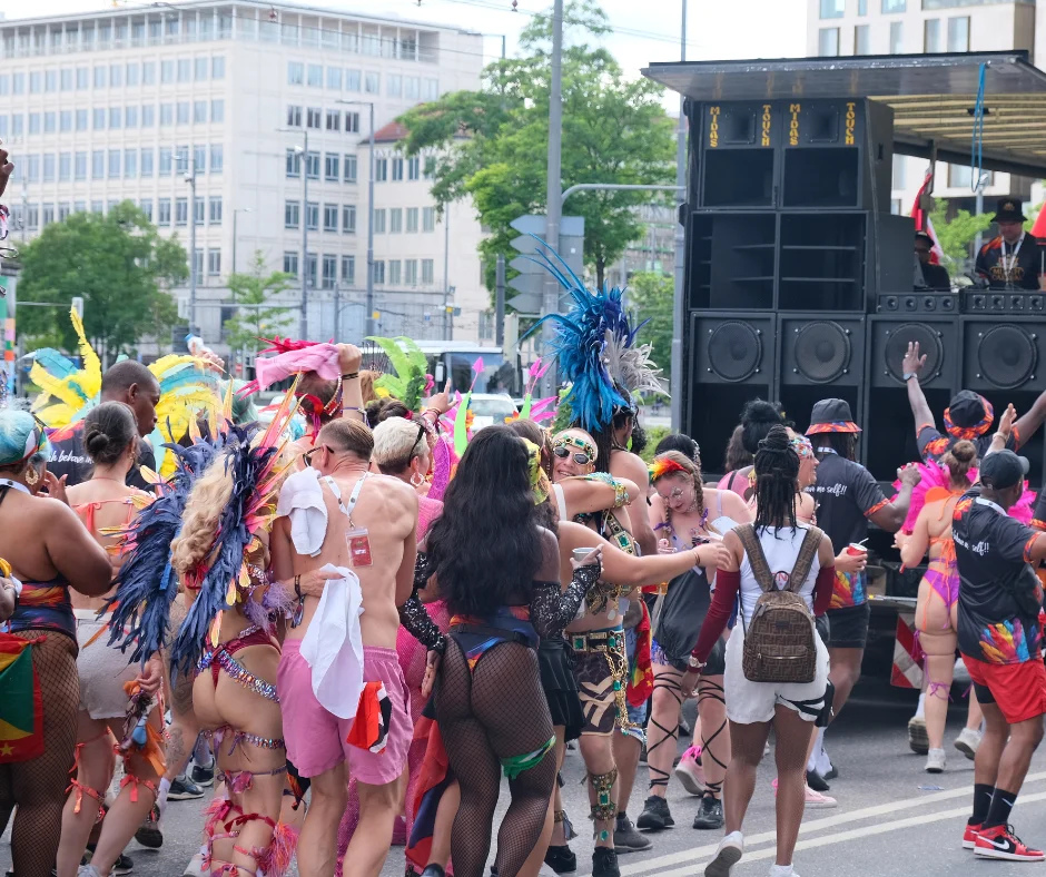 Carnival crowd dancing alongside the soca music truck at Munich Carnival 2026 road march