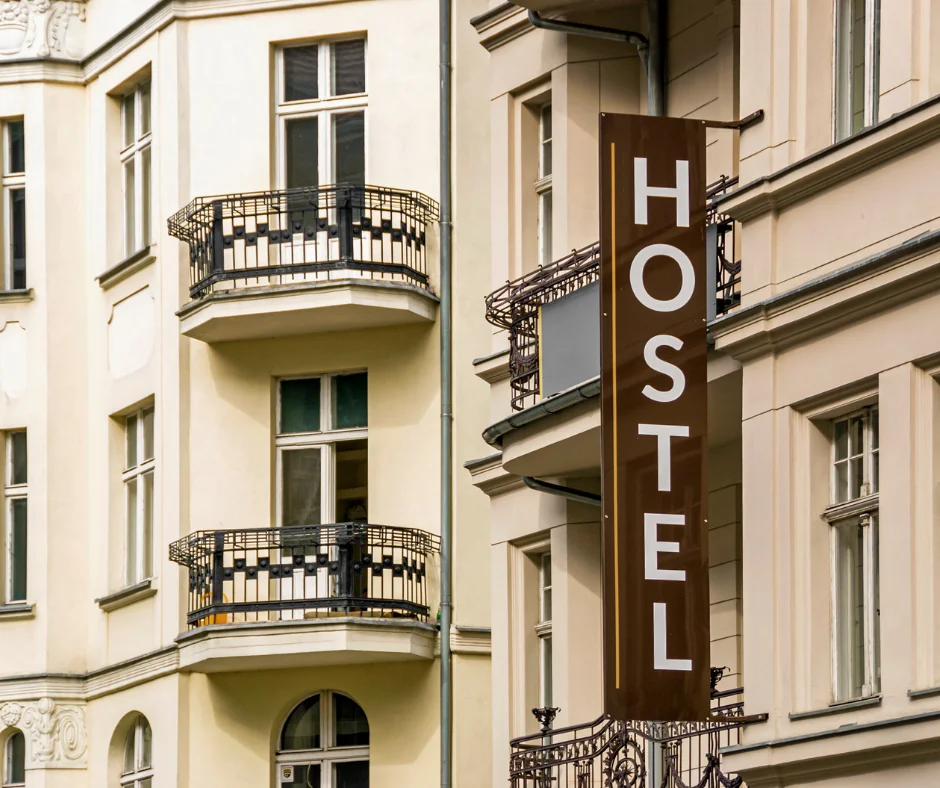 Hostel sign outside a European building, representing affordable hostel stays for Carnival 2026 visitors.