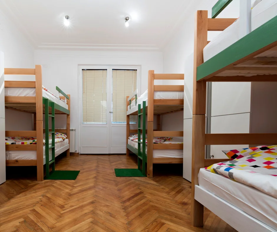 Shared hostel dorm room with bunk beds, showing a budget-friendly place to stay for Carnival 2026.