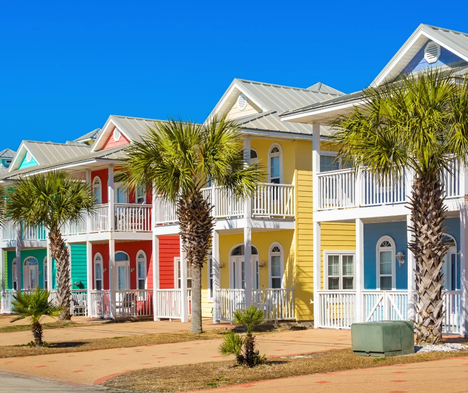 Colorful vacation rental homes with palm trees, representing Airbnb-style places for where to stay for carnival.