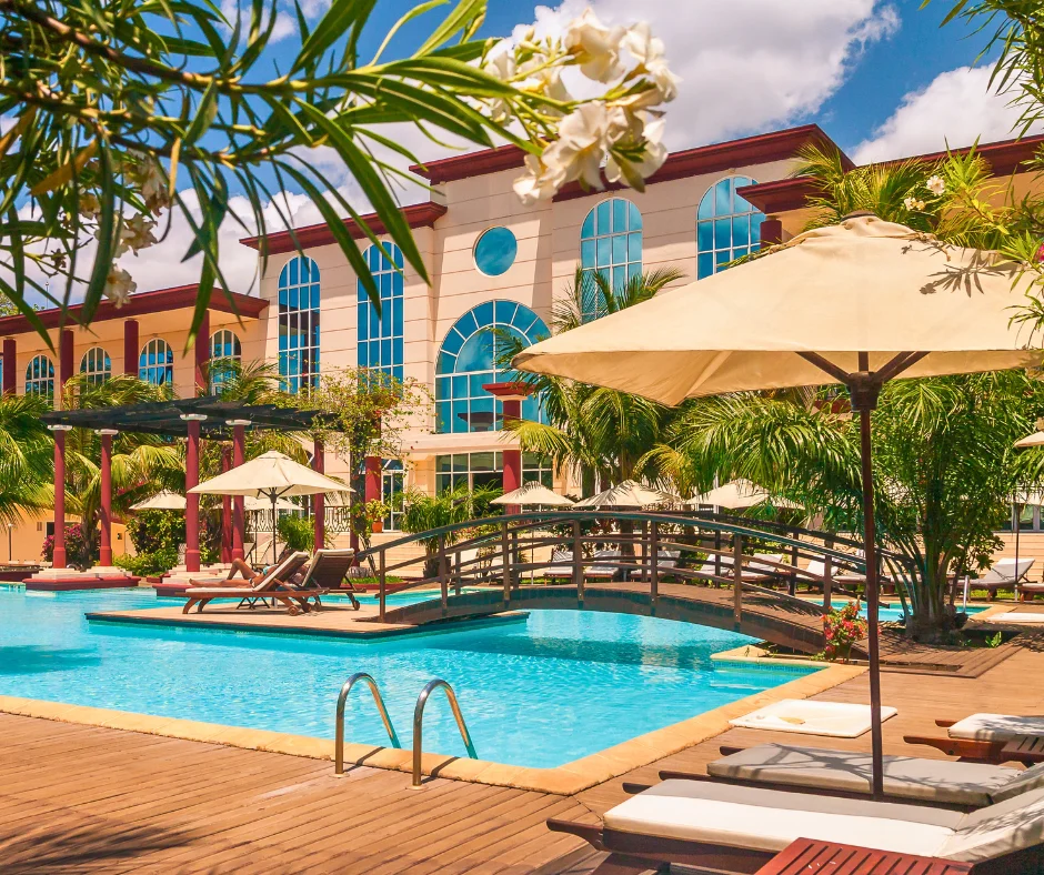 Tropical resort pool with lounge chairs and palm trees, showing a Caribbean hotel option for where to stay for carnival.