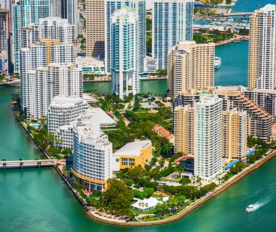 Aerial view of waterfront hotels and high-rise buildings in a U.S. city, representing city hotel options for travelers deciding where to stay for carnival.