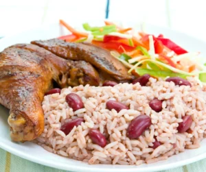 Rice and peas with roasted chicken and fresh salad, a classic plate of Caribbean foods at carnival