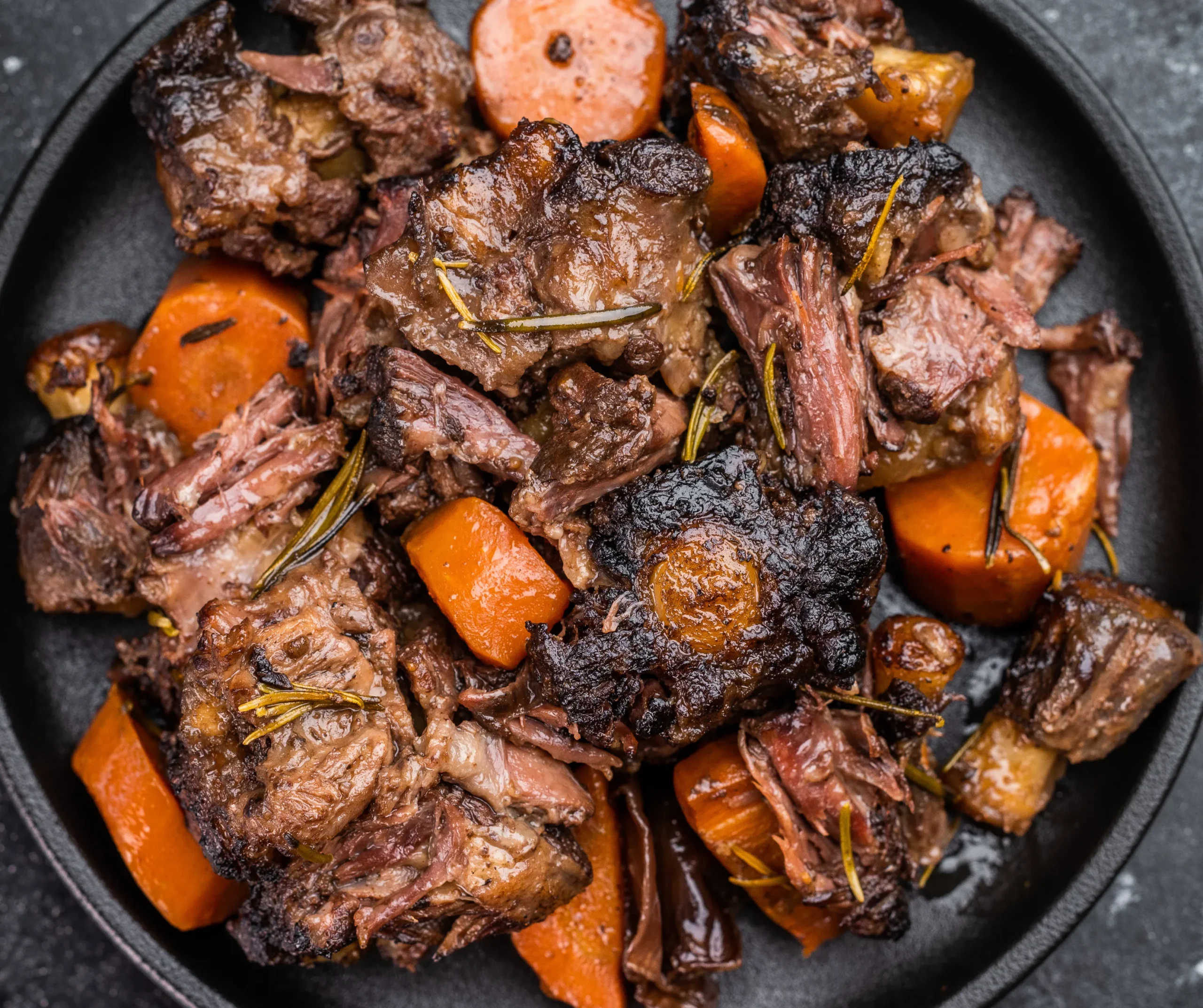 Stewed Oxtail meat with carrots and herbs, a hearty example of Caribbean foods at carnival