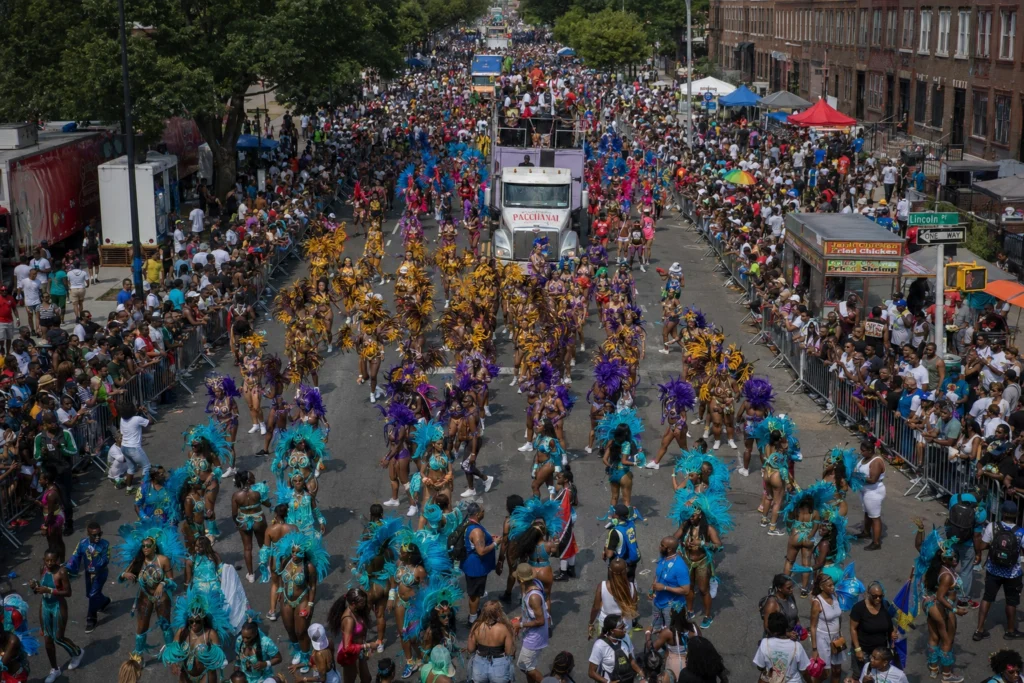 Aerial view of the New York Carnival parade crowds and masqueraders along Eastern Parkway Brooklyn