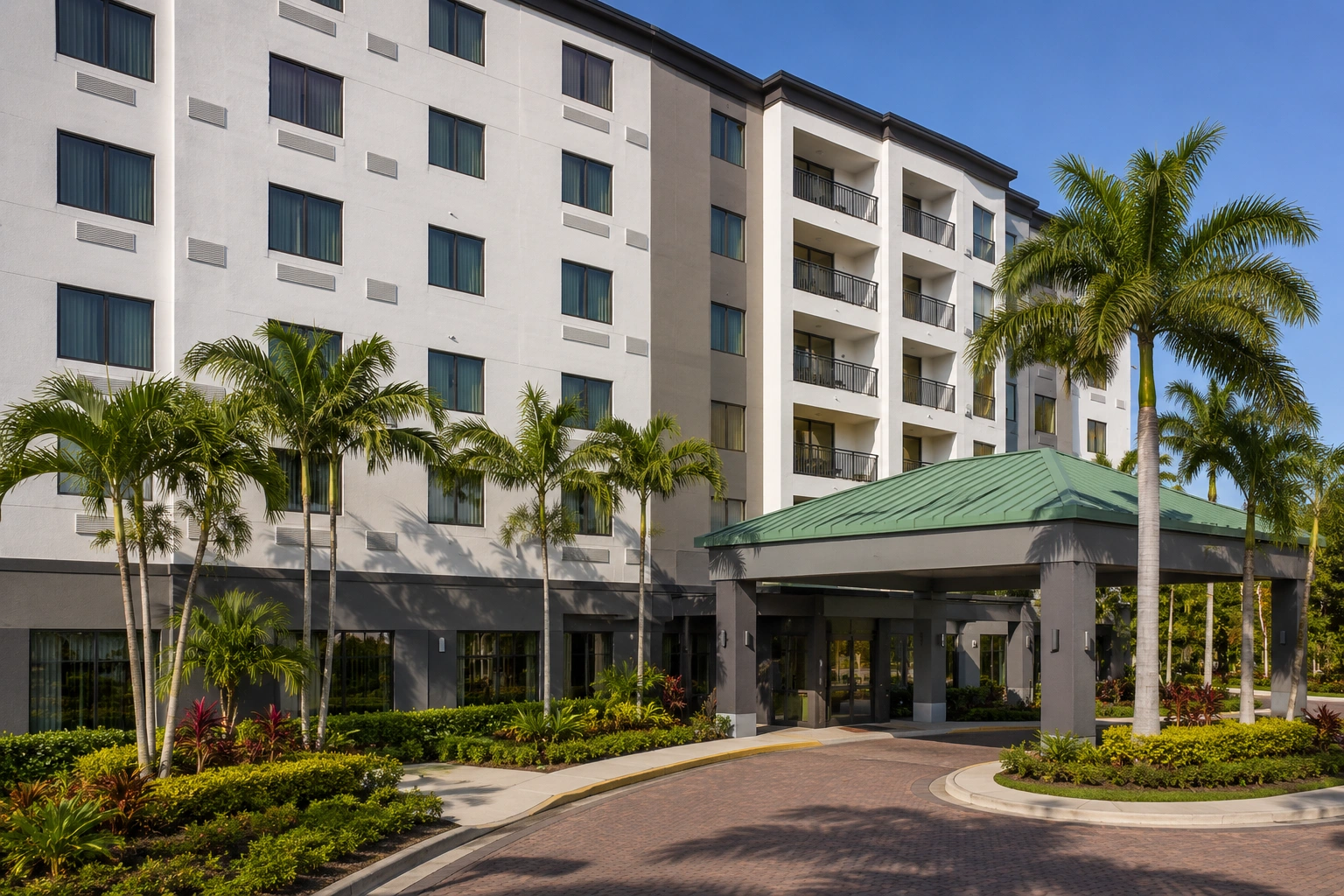 Courtyard by Marriott Miami at Dolphin Mall exterior with palm trees and covered entrance near the Miami Carnival Fairgrounds area.