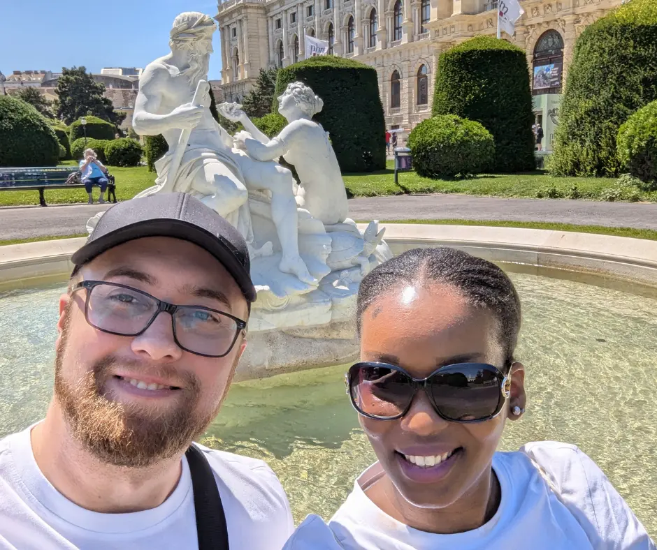 CarnivalVibez team exploring Vienna Austria in front of a classical fountain and museum — what to do when carnival is canceled