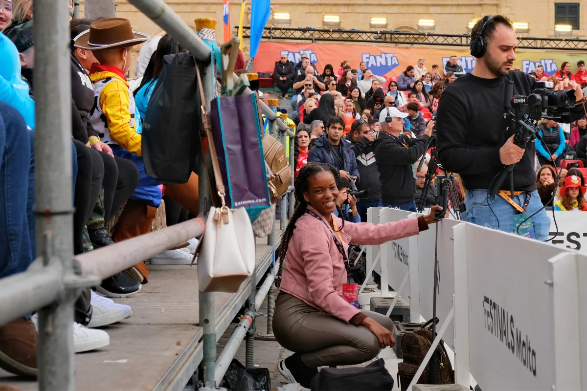 Carnival Vibez blogger smiling at ringside during Malta Carnival performances in Saint George's Square