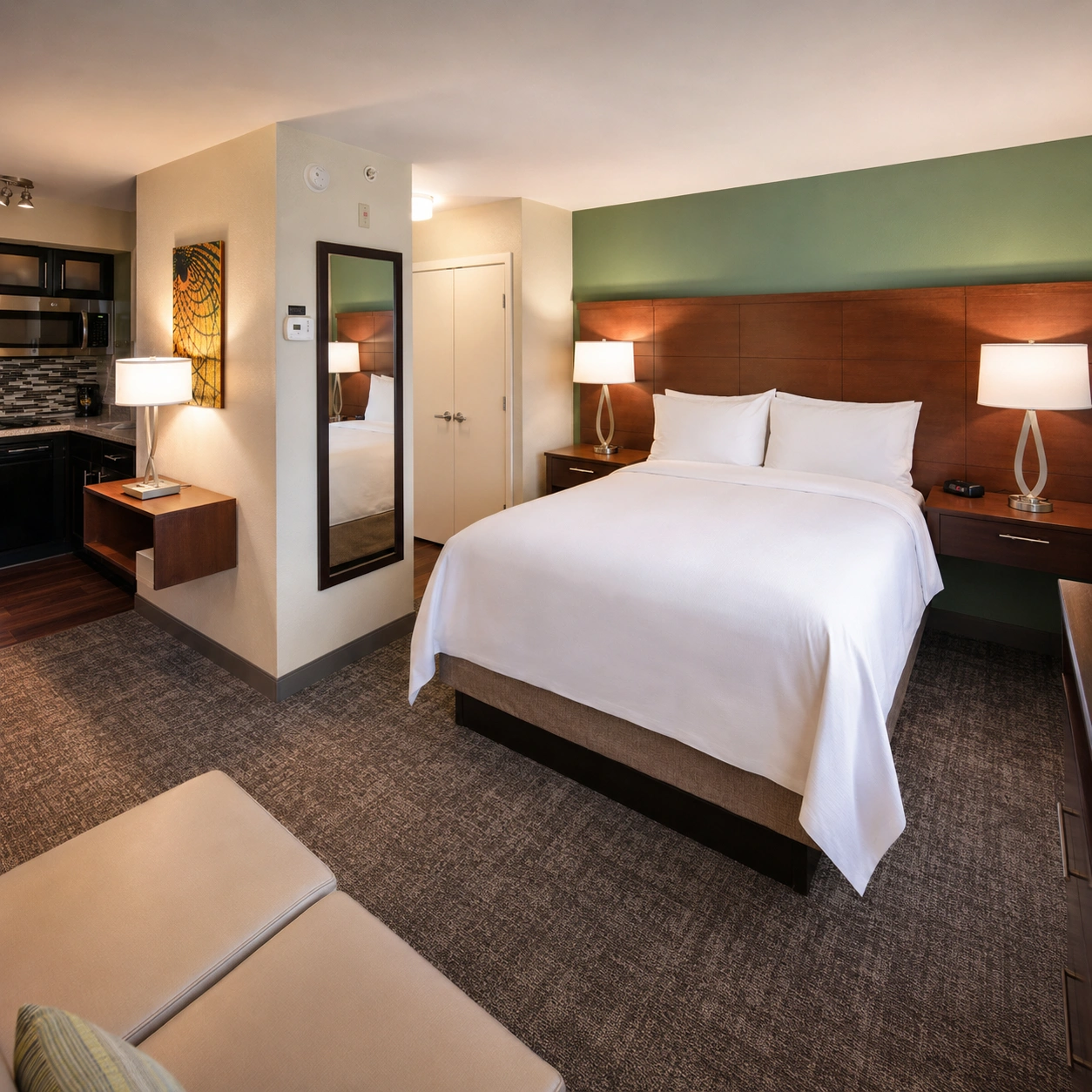onesta ES Suites Fort Lauderdale Plantation guest room with a queen bed and kitchenette for Miami Carnival visitors staying in Broward.