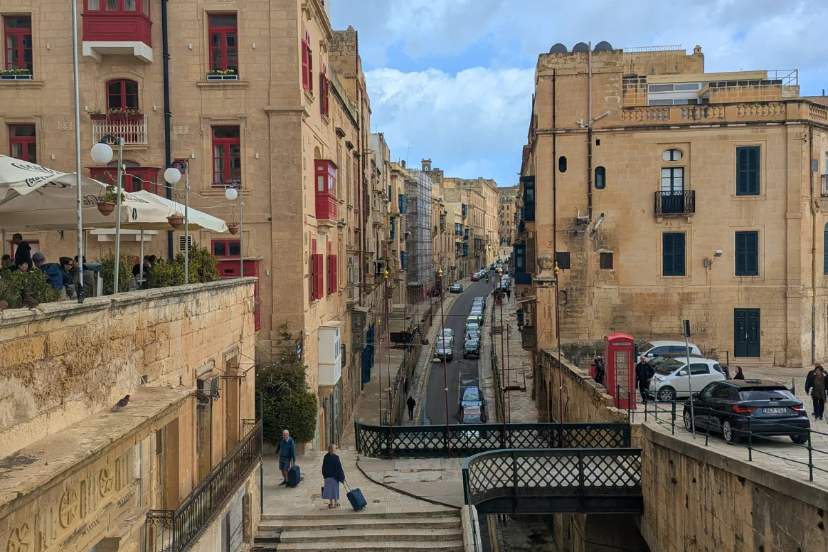 View over a Valletta street with traditional red balconies and rooftops