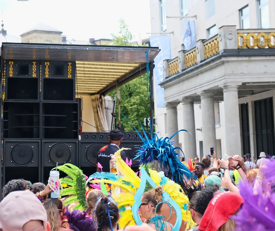 Colorful carnival participants dancing beside a music truck in central Munich during Munich Carnival