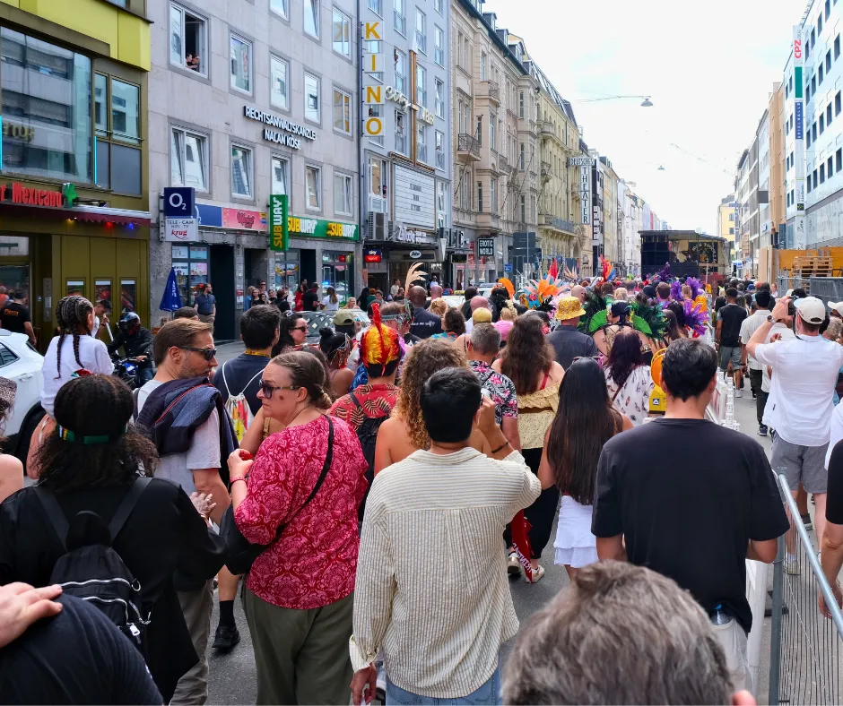 Crowds and costumed carnival participants filling a central Munich street during the Munich Carnival parade